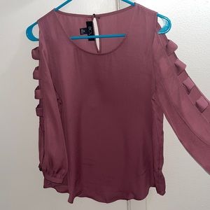 long sleeve top with cut outs along the sleeves